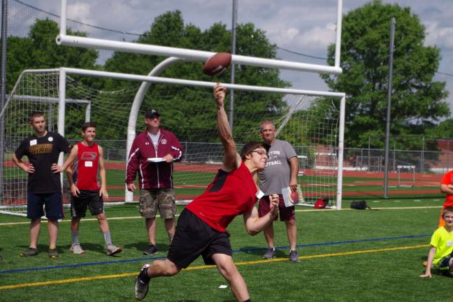 Children gather to punt, pass and kick Fifteen-year-old Devin Mager throws in the pass contest. He finished in 1st place overall in his age group.