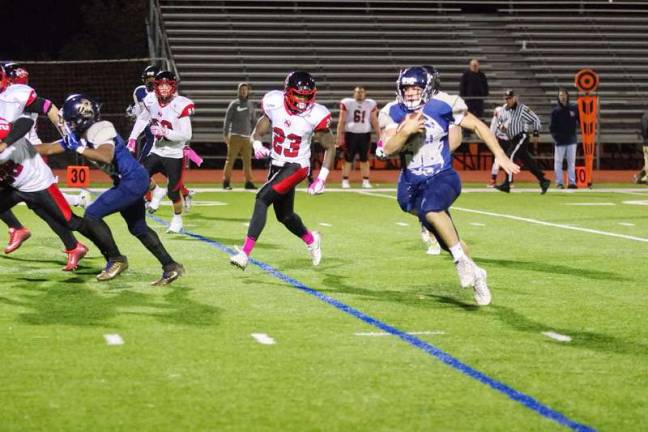 Sussex running back Ben Cramer advances the ball with Watertown defenders in pursuit.