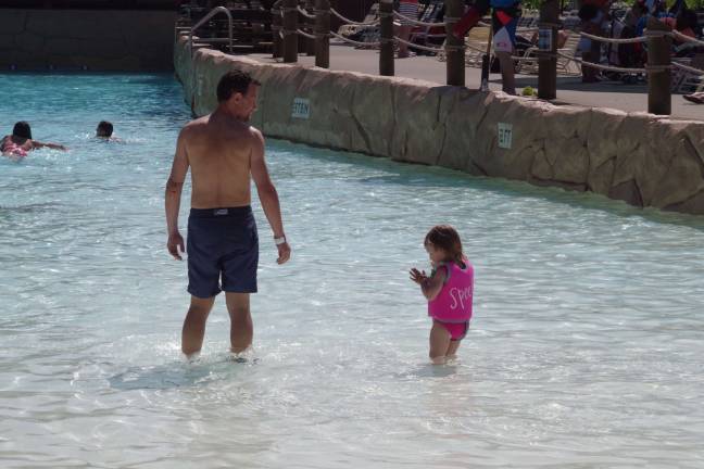 A young girl is cautious about the cool water in the Hightide Wavepool.