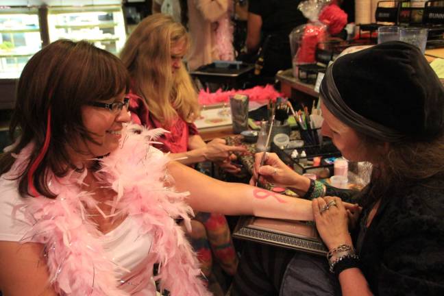 Breast cancer fundraiser held at Smokey's Michele McQuillan of Glenwood gets tattooed by Elyzabeth Farrell of Greenwood Lake at Avon for a Cure