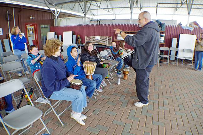 Everybody had a chance to solo and get into the act during the drum circles. Composer and master musician Richard Reiter leads one of two drum circles held in the covered patio area at Heaven Hill Farm during the Vernon Earthfest 2014 celebration. Although he makes the rounds with drums, his primary instruments are woodwinds.