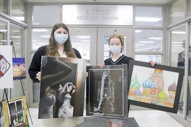 Devin Sellinger (left) and sophomore Danielle Kelly show their pieces of artwork that have earned selections at this year’s Sussex County Teen Arts Festival (Photo provided)