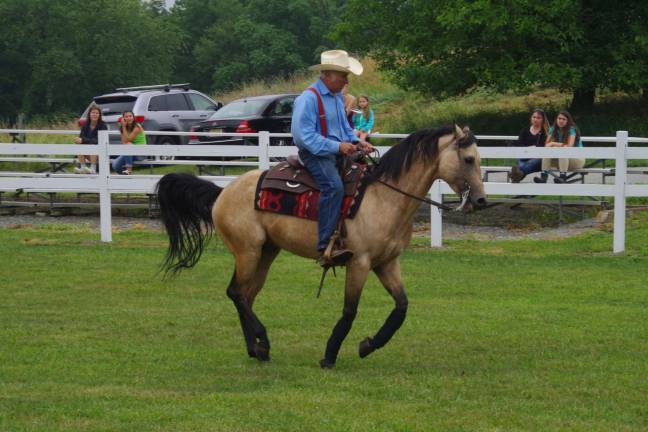 Photo by Chris Wyman Donning a cowboy hat, Bruce Martin of Franklin&#x2019;s Quiet Valley Farm and his horse Strait Up Dunit present a program on reining a horse at Lusscroft Farm's All Things Equine Festival.