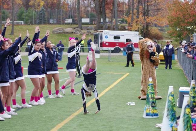 The Pope John Lion and the school cheerleaders pump up the football fans.