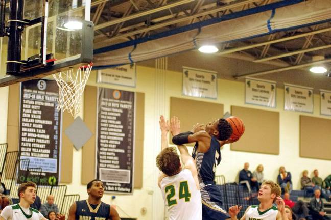 Pope John's D'Andre Reed in the midst of a shot makes contact with North Hunterdon defender Paul Woolhouse in the third period. Reed scored four points and grabbed three rebounds.