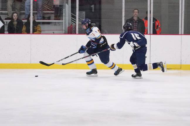 Roxbury defeats Sparta-Jefferson In the first period Sparta-Jefferson's Matthew Espinosa is in control of the puck while Roxbury's Brian Westergaard trails behind. Espinosa scored Sparta-Jefferson's only goal.