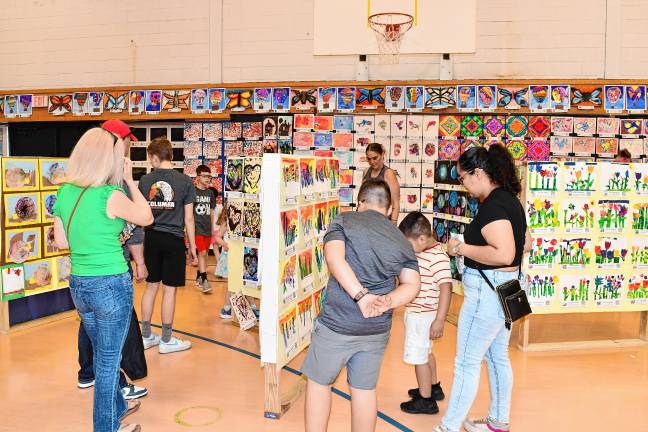 Photos: Artstanding 2025 in Vernon <b>Residents look at student artwork during Artstanding 2025 on Friday, May 16 at Lounsberry Hollow Middle School in Vernon. The annual event highlights the work of students in grades K-12 in the visual, performing and practical arts. (Photos by Maria Kovic)</b>