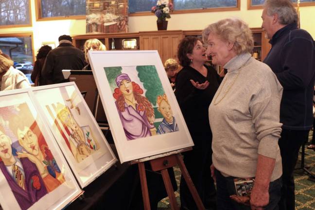 Jean Mize of Barry Lakes enjoys the artwork being displayed by the Highland Lakes Artists Group.