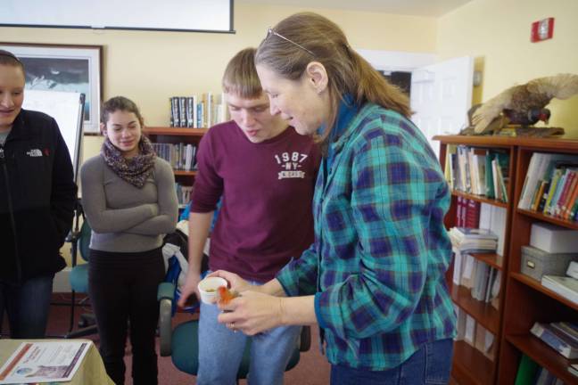 Wallkill Refuge hosts Great Backyard Bird Count Giselle Smisko of the Wantage-based Avian Wildlife Center is shown hand feeding a one-legged Red-bellied Woodpecker.