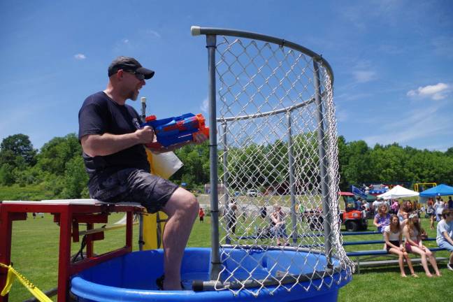 Vernon Little League manager and board vice president Steven Glick is shown taunting wouldbe dunkers. He spent much of the day falling in and then climbing out of the dunk tank to help raise money for his favorite cause.
