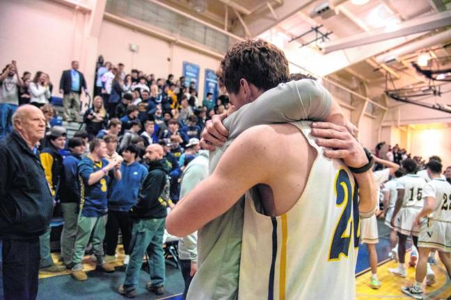 Ben Jurewicz gets a hug from coach Connor Healy.