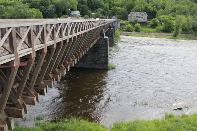 Water was high and swift under the Roebling Bridge at Lackawaxen Wednesday morning. (Photo by Pamela Chergotis)