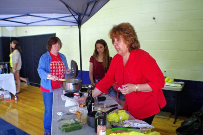 Vernon Township High School Italian Language teacher Lea Haddeland is shown cooking pesto for her audience.