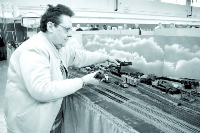 Railroad enthusiasts get on board Arlene Passage of the Pleasant Valley Lake section of Vernon has been helping build the miniature sets for years. Here she works on the junkyard, one of her regular contributions to the model train layout.