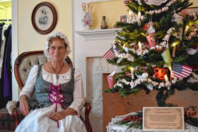 A trip back in time <b>DAR member Wendy Wyman tells visitors about a second-floor guest bedroom in the DAR Van Bunschooten Museum in Wantage. </b>