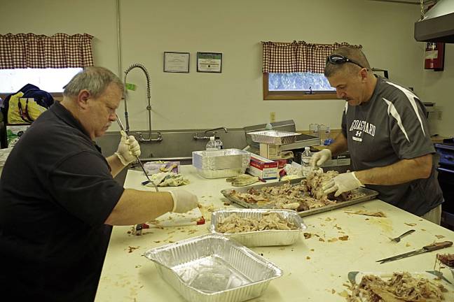 McAfee FD hosts 3rd annual pig roast Working in the firehouseís kitchen were Roy Metz and Tim Storbeck. Both men are McAfee residents. Metz is a firefighter and Storbeck is a tried and true volunteer.