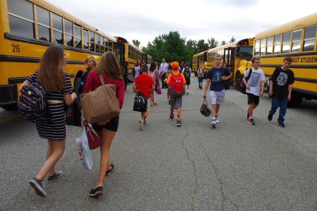 Hundreds of students debarked from the buses and headed into the waiting homerooms inside the school on the first day of school.