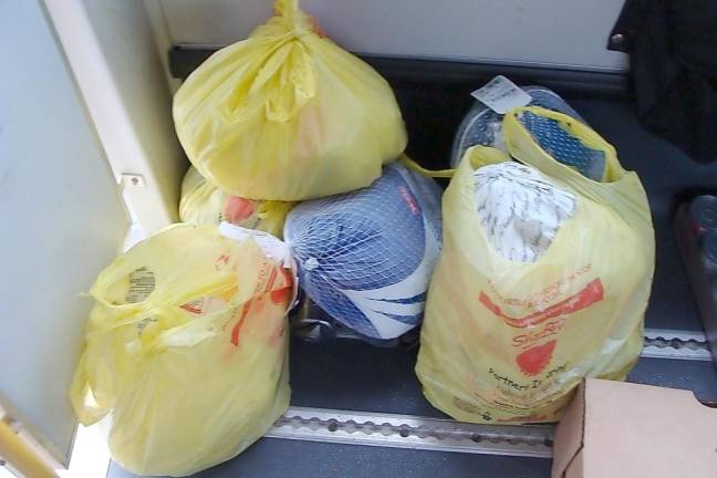 Frozen turkeys were piling up on the bus.