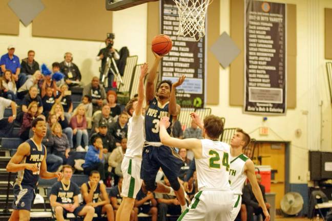 Pope John's Eddie Davis raises the ball towards the hoop in the fourth period. Davis scored 12 points and was named all-tournament team player.