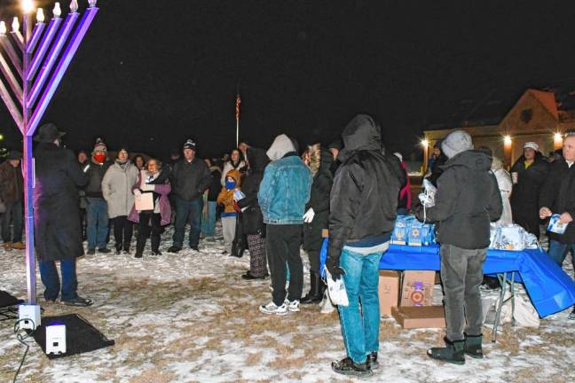 Photos: Menorah lighting in Vernon <b>Residents gather for a menorah lighting Thursday, Dec. 26 in Vernon. Candles traditionally are lit in menorahs for each of the eight nights of Hanukkah. The Jewish holiday began Dec. 25 and ends Jan. 1. (Photo by Maria Kovic)</b>