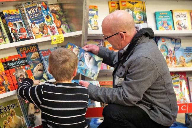 Books are carefully examined at the Cedar Mountain Book Fair.