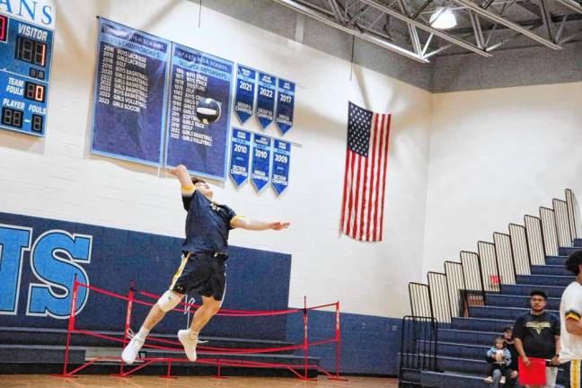 Vernon's Tristan Santiago leaps toward the ball during a serve. He is credited with three digs, one assist and two aces.