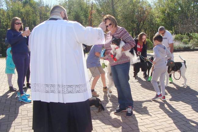 Father Chris Barkhausen, Pastor of St. Francis de Sales Church blesses pets on the Feast Day of St. Francis of Assisi.