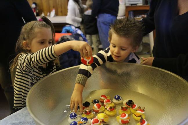 American Legion hosts lunch with Santa Jazmin and Nathan Houghtaling of Sussex pick a duck to win a prize.