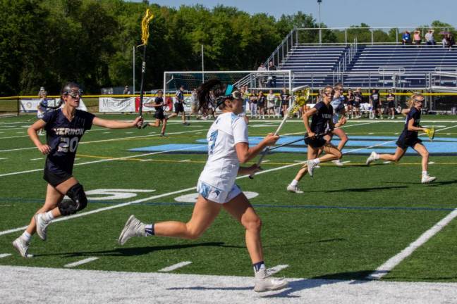 VLX1 Vernon attacker Makenna Thomas (20) chases Sparta Spartans midfielder Uma Kowalski (7) during the first round of the girls varsity lacrosse state tournament Thursday, May 25 at Sparta High School. Kowalski scored the winning goal with seconds to spare, helping the Spartans beat the Vikings, 15-14. (Photos by Aja Brandt)