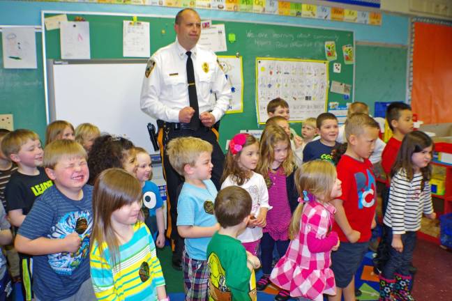 Photo by Chris Wyman During the final minutes of the presentation, Vernon Police Department Lt. Daniel B. Young teaches the kids how to put on an &#xec;I mean business&#xee; look and a few others too.