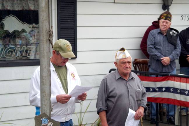 Veterans and their families listen as Quartermaster Bob Constantine, a former Post Commander read from a message entitled &quot;Remembering a Veteran&quot; written by veteran Jochem R. Kresse of Clifton.