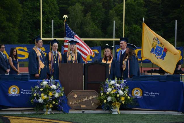 Students perform the National Anthem during graduation.