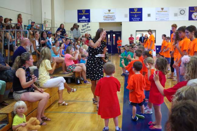 At center, teacher Lisa Haw reviews what the children learned throughout the week.