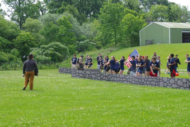 Sophomores finish school year with a bang, a splash Scene is shown behind a rock wall.