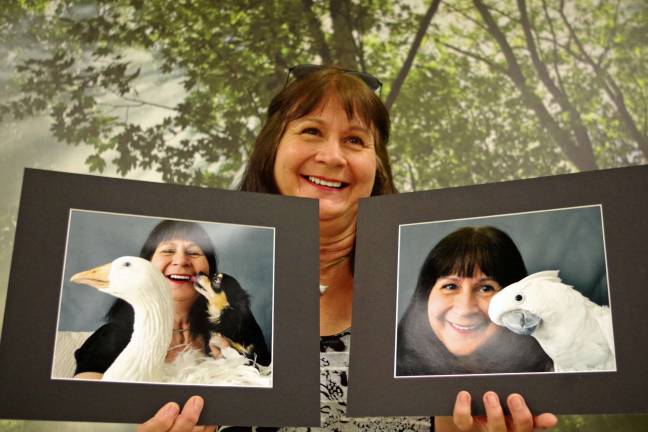 PHOTOS BY CHRIS WYMAN Standing in front of a framed photograph in the Vernon Senior Center, photographer Leesa Beckmann of Barry Lakes holds two self-portraits that she created for the Vernon Camera Club meeting featuring a presentation by Highland Lakes cinematographer/photographer Rob Haley.