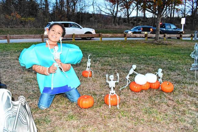 Photos: Trunk or Trail in Vernon <b>Aiden Guillen of Vernon sets up skeletons on the pumpkins.</b>