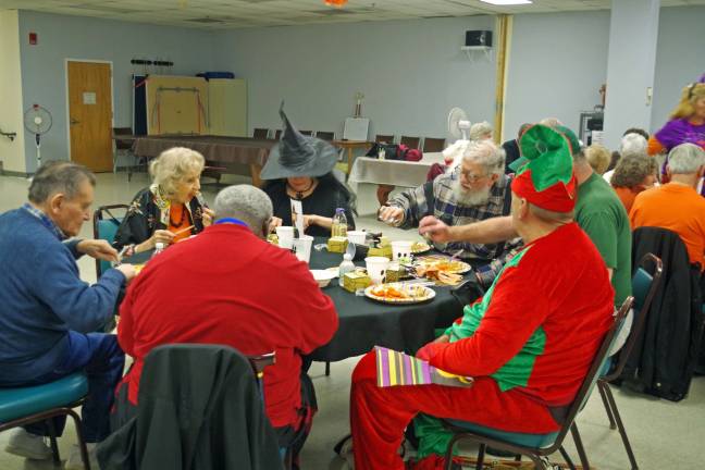 Seniors compete and eat at Halloween party Seniors in costume enjoying lunch at the Vernon Senior Center.