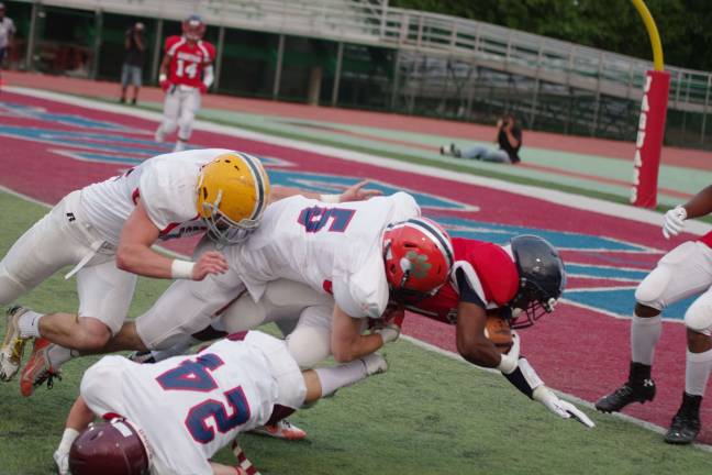 The West defense stop an East ball carrier just short of the goal line.