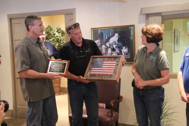 Derek and Kevin Cooke, owners of Abbey Glen, were presented with a flag encased in a frame with all the grommits that were left in the ashes from last year's American flag retirement ceremony.It was presented by Reenee Casapulla, whose husband made the box.