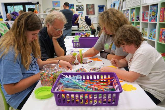 The Widney family enjoys crafts together at the Painted Grape.