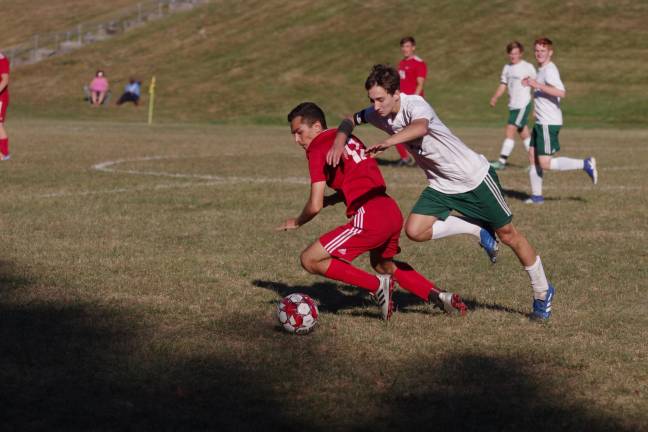 A High Point Wildcat and Sussex Tech Mustang pursue the ball.