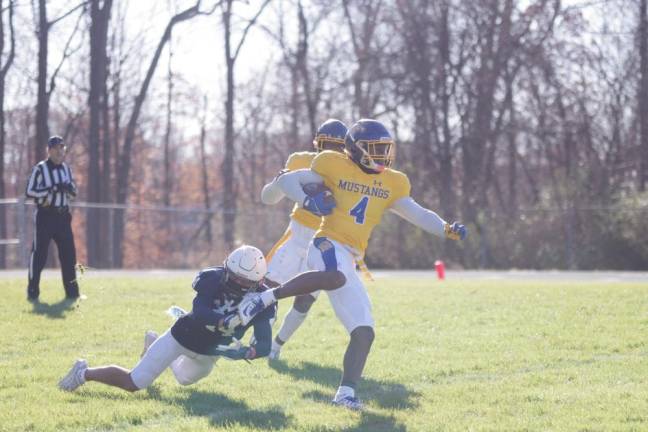 Monroe College ball carrier Charles Alia avoids a defender during a kick return.