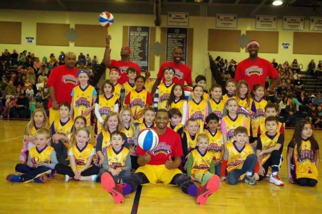 The Harlem Wizards pose with some young fans.