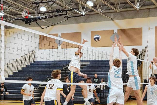 Vernon's Ben Jurewicz strikes the ball toward Sparta players. He is credited with five kills, one block, two digs and one ace.