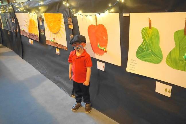 William poses with the apple he helped paint (Photo by Vera Olinski)