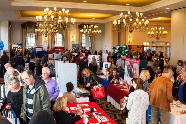 Attendees browse EXPO exhibitor booths in the Emerald Ballroom at Crystal Springs Country Club (EXPO 2015). Photo by D. Becker