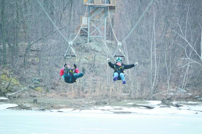 Winter fun can come from the air with a zipline Photo by Zoom Zipline Alexis Tarrazi and Mark Vanderhelm make their way down the zipline.