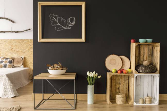 Modern room with DIY wooden furniture and blackboard wall