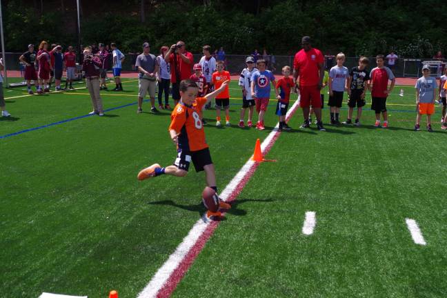 Children gather to punt, pass and kick Ten-year-old Robert McCullough shows good form in the kick contest. He finished in 2nd place overall in his age group.