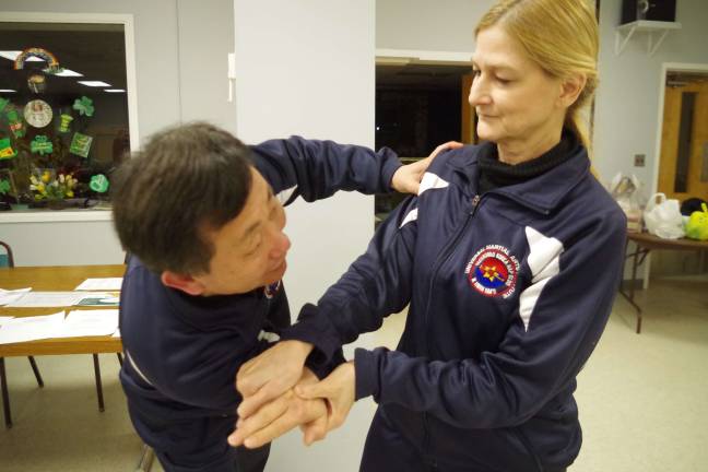 Vernon Woman's Club learns about self-defense Branchville resident Carole Lynn Servideo is shown executing a series of Hapkido hand techniques with Grandmaster Ik Hwan Kim of Kimís Universal Martial Arts Institute in Lafayette.